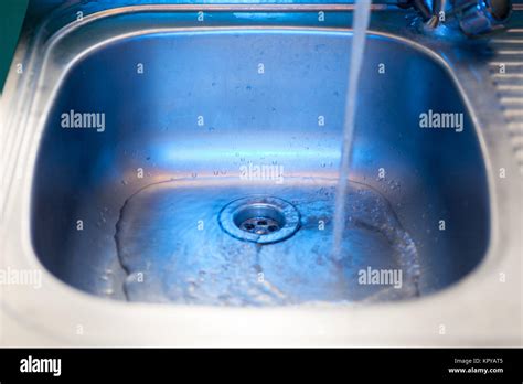 A Stream Of Clean Transparent Fresh Water Flows From The Steel Shiny