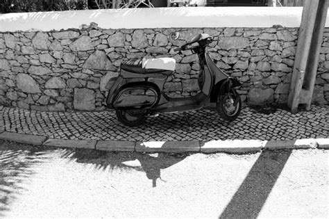 Premium Photo Motor Scooter Parked On Sidewalk Against Surrounding Wall