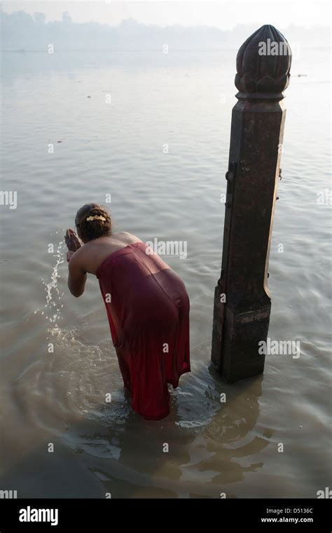 A Hindu Devotee Makes Offerings In The Sacred Yamuna River At Vishram