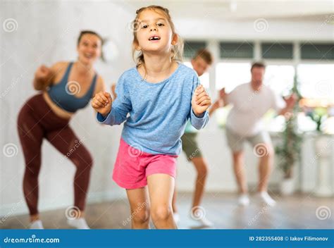 Cute Little Girl Practicing Dance Movements with Her Family Members ...