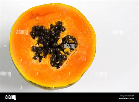 Papaya Carica Papaya And Seeds Cut In Half On A White Background