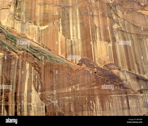 Desert Varnish Streaks Sandstone Cliff Walls Above Escalante River