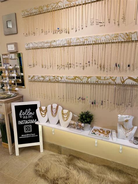 A Jewelry Store With Gold And White Necklaces On Display