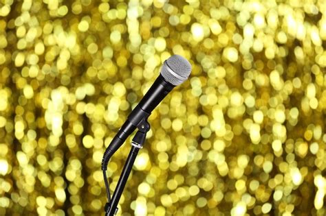 Premium Photo | Microphone on stand on golden background