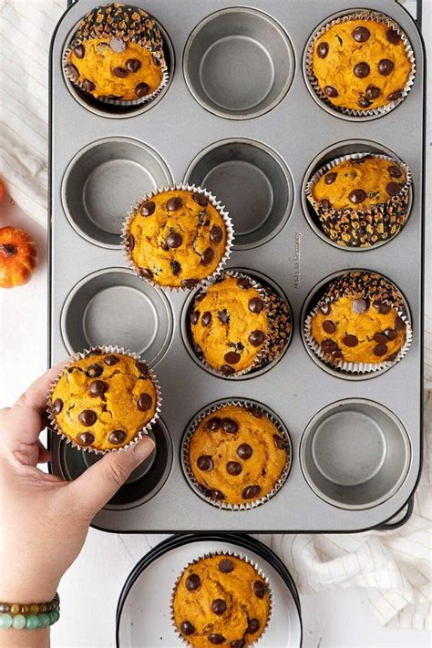 A Muffin Tin Filled With Orange Chocolate Chip Muffins