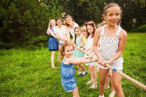 Premium Photo The Group Of Girls Of All Ages Playing Tug Of War In