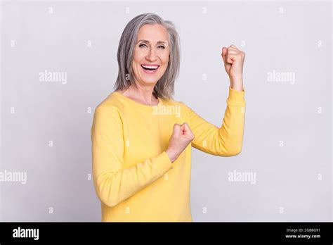 Photo Of Happy Excited Good Mood Cheerful Mature Woman Raise Fists In