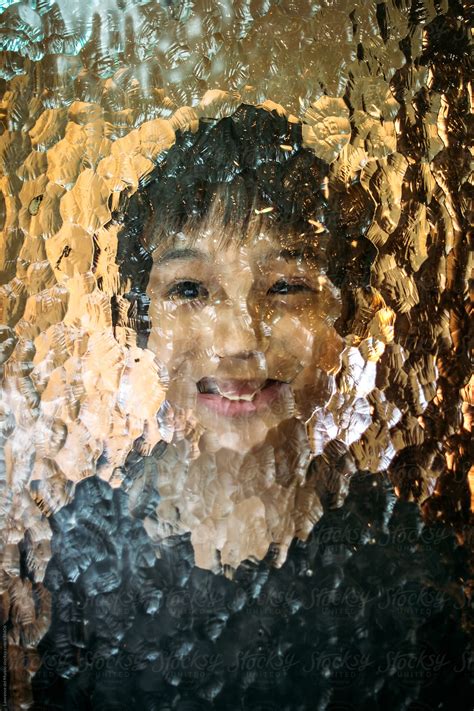 Experimental Portrait Of A Young Boy Behind A Textured Glass Del