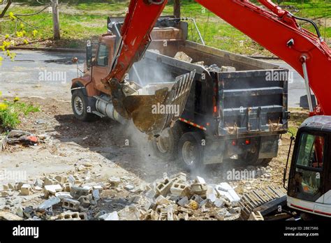 Backhoe Excavator Scoop Loading From Building In The Construction