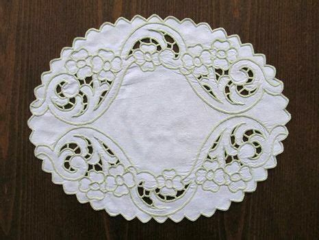 A White Doily Sitting On Top Of A Wooden Table