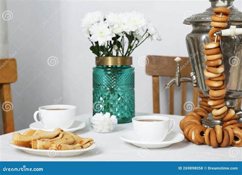 Vintage Samovar Cup Of Hot Drink And Snacks Served On Table Indoors