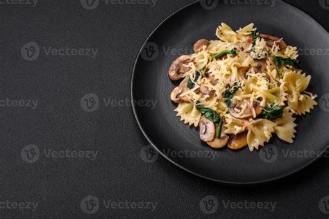 Delicious farfalle pasta with mushrooms, cheese and spinach with spices ...