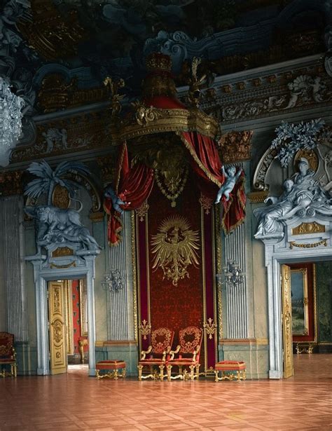 An Ornately Decorated Room With Gold And Red Curtains