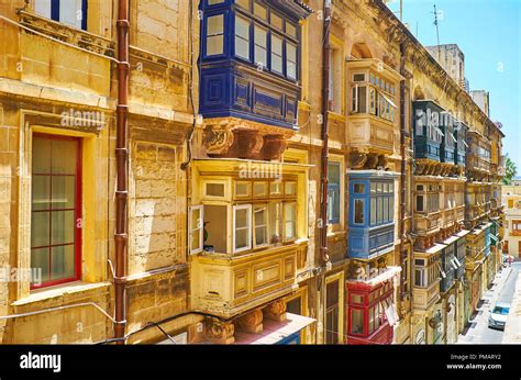 Observe Traditional Wooden Maltese Balconies Typical For Historical Stone Edifices In Valletta