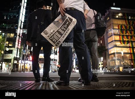 People Receive An Extra Edition Of A Newspaper Reporting Japanese Born