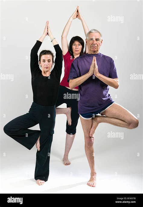 frontal view of three people in the tree pose Stock Photo - Alamy