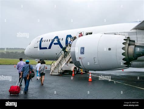 Passengers boarding LATAM airline Dreamliner Boeing 787, during wet ...