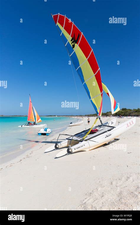 Tourists on Cayo Coco beach, catamaran on the shore, sailing, sandy ...