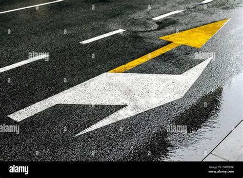 Bus Yellow Arrow Showing Straightforward Sign On The Road On A Rainy