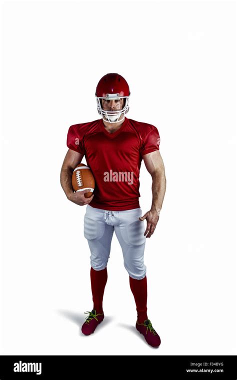 American football player holding ball Stock Photo - Alamy