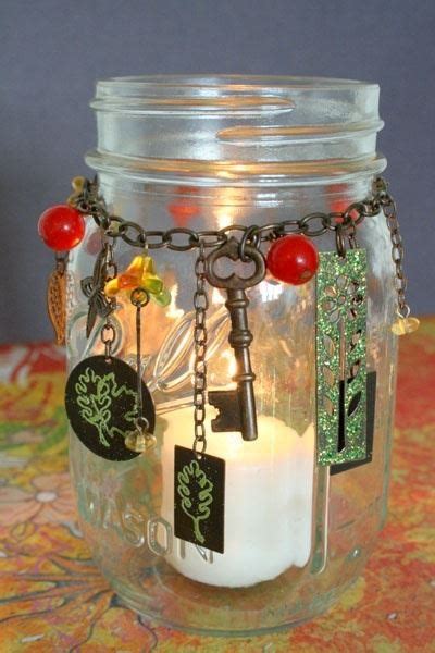 A Jar Filled With Lots Of Key Chains And Other Items Next To A Lit Candle