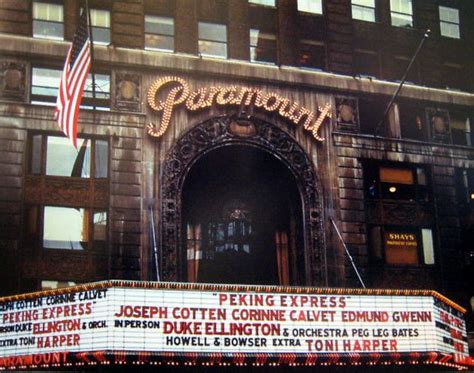 An Old Theater Sign In Front Of A Building