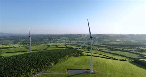 Large Wind Turbine With Blades On Green Field Aerial View Of Green