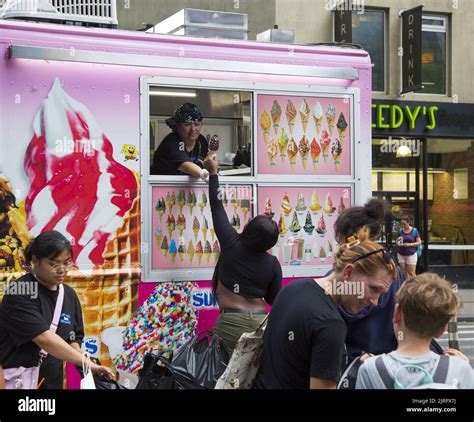 People Buy Softee Ice Cream Cones On A Hot Summer Day At 32nd Street