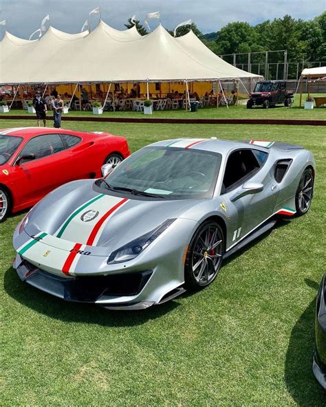 Three Sports Cars Are Parked On The Grass