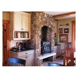 Wood Stove In Stone Alcove Rustic Dining Room Minneapolis By