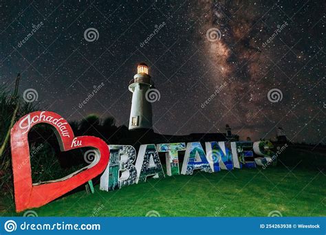 View of an Old Lighthouse Under the Starry Night Sky in the Green Field ...