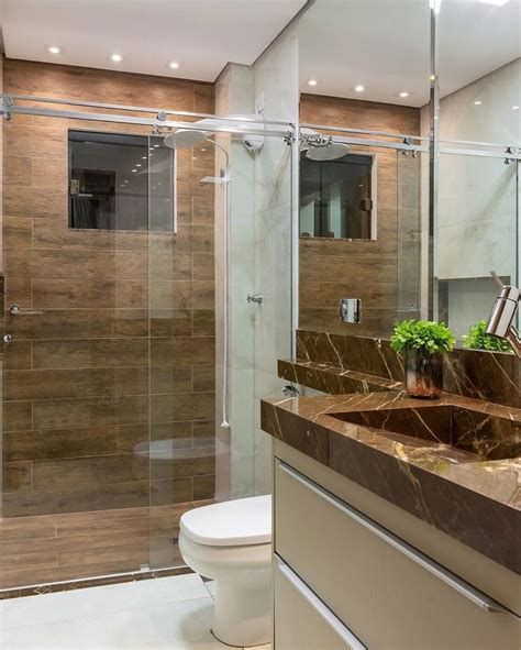 A Bathroom With A Sink Toilet And Glass Shower Stall In The Middle Of It