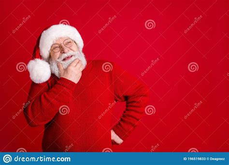 Photo Of Dreamy Thoughtful Old Man In Santa Claus Headwear Look Copyspace Touch Chin Face Think