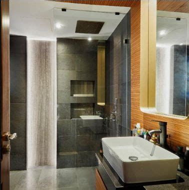 A Bathroom With A Sink Mirror And Shower Stall In The Middle Of The Room