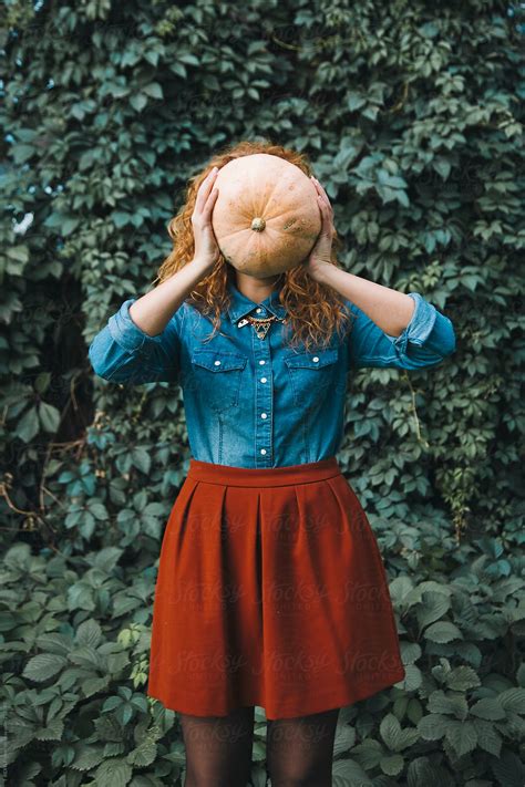 Woman Holding Pumpkin In Front Of Her Face Del Colaborador De Stocksy