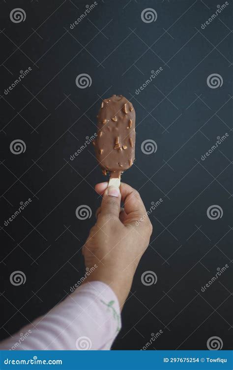 Hand Holding Melting Ice Cream On Dark Background Stock Photo Image