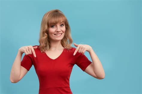 Happy Surprised Blonde Young Female Smiling Broadly At Camera Pointing