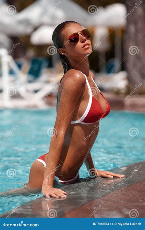 Woman In Swimming Pool Beautiful Girl In The Red Bikini On The Sun