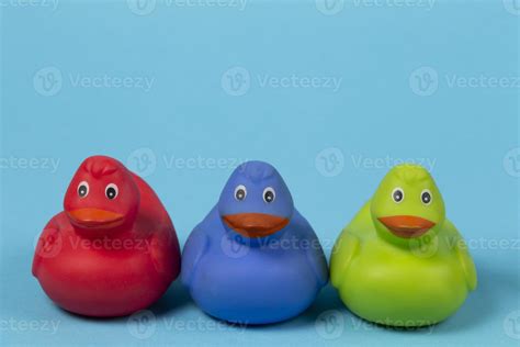 Multi-colored rubber ducks on a blue background. 19089356 Stock Photo ...