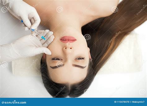 Attractive Woman At Plastic Surgery With Syringe In Her Face Stock