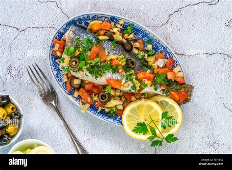 Mediterranean Sea Bass Stuffed With Tomatoes Lemons Fennel And Olives