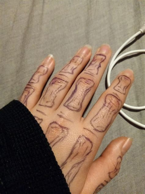 A Person S Hand With Tattoos On It Next To An Electrical Cord And