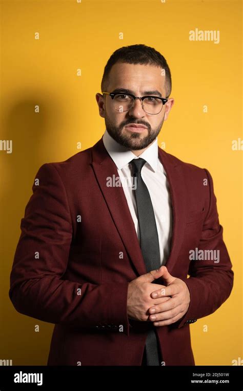 Half Length Portrait Of Handsome Man Standing Half Turn In Burgundy