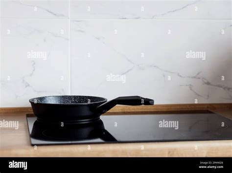 Frying Pan On Modern Black Induction Stove Cooker Hob Or Built In