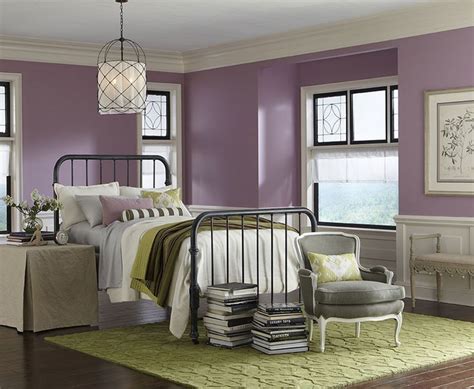 a bedroom with purple walls and white furniture