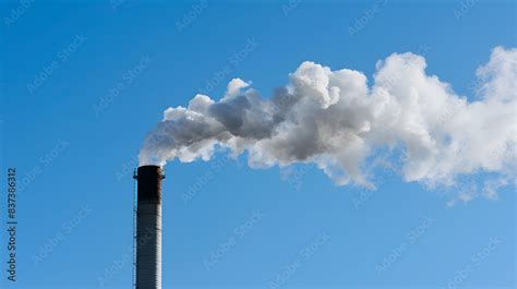 Smokestack Emits Thick Smoke From A Pipe Contrasting Against A Clear