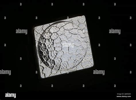 A lumpy piece of translucent glass, like the moon Stock Photo - Alamy