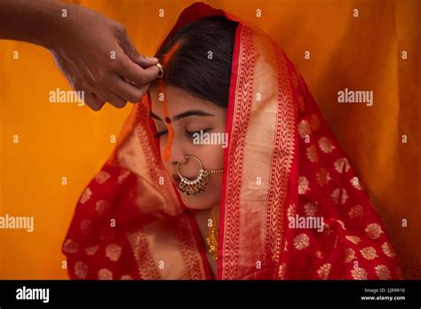 Bride from Bihar in the midst of sindoor ceremony, in a traditionally ...