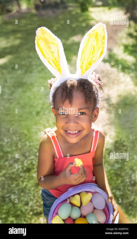 Cute And Beautiful African American Girl Wearing Bunny Ears Eats With