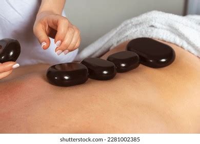 Massage Therapist Places Hot Stones On Stock Photo 2551427495